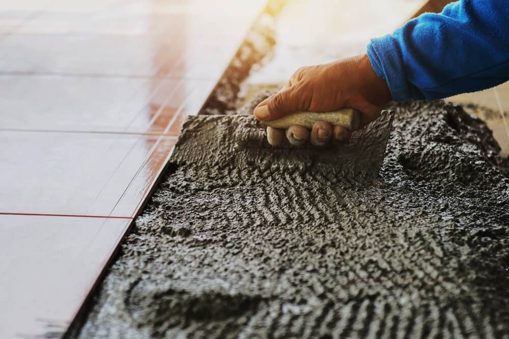 https://gibtilingperth.com.au/wp-content/uploads/2021/01/closeup-hand-construction-worker-laying-tile-floor-min.jpg